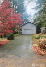 Driveway slopes up to the house from the street.