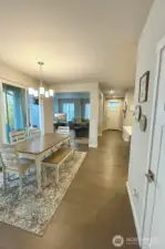 View of entry and living room from dining room, large slider offers access to patio.