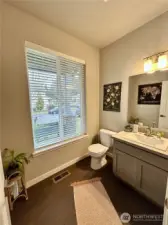 Main floor 1/2 bath just off entry with hardwood floors.