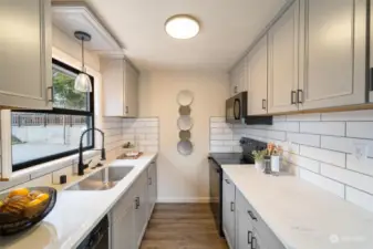 Efficient kitchen featuring updated appliances, a stylish tile backsplash!