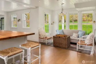 This charming nook offers flexibility as a dining area or a relaxing sitting space.