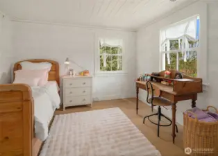 Comfort and style combine in this inviting second bedroom, offering versatility and tranquil views.