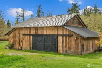 Lush grounds and a charming barn offer endless possibilities.