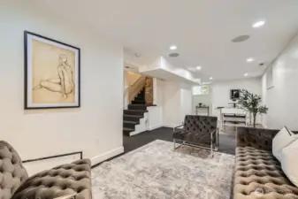 Another view of the lower level family room looking back at the stairs from the main floor and the game area beyond.