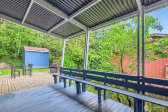 Covered deck with built-in seating off of the main floor family/dining area.