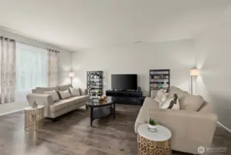 The expansive living room features a huge picture window…