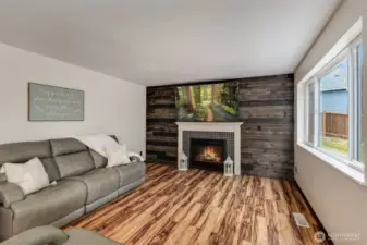 Inviting living room with gas fireplace and reclaimed wood wall