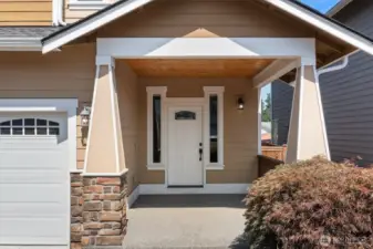 Lovely covered front porch w/wood accents!