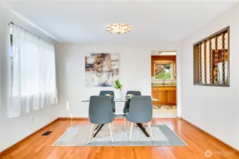 The living space opens into a dining area with a south window and a doorway to the eat-in kitchen.