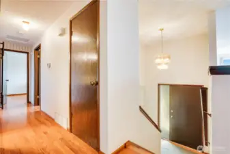 The upper hall includes this coat closet right at the top of the stairs and a built-in linen closet just outside the full bath.