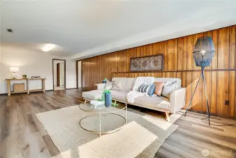 The homeowners installed LVP flooring with SMARTCORE underlayment as well as overhead lighting. The paneling is 1970s original.