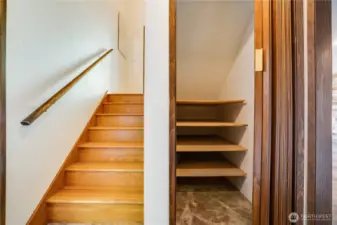 An under-stair storage closet completes the downstairs living area.