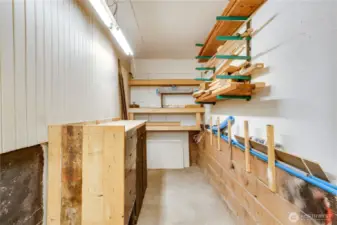 With shelving and work surfaces, this storage room helps free up garage space and keep things more tidy.