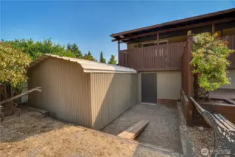 The garden shed stands just outside the back door into the storage room.