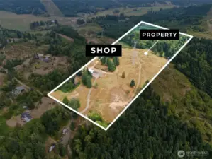 Rolling property with trees and open space on a hillside with a 40 x 48 shop connected to water and septic