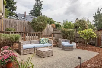 Private and fenced backyard features a patio and garden space.