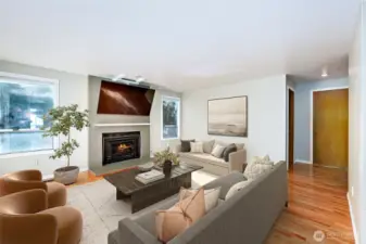 Family room with gas fireplace. *TV doesn't convey. Other furniture is digitally staged.