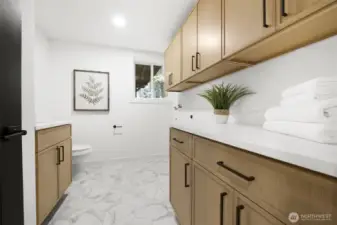 Downstairs laundry and 1/2 bath with plenty of cabinet storage.