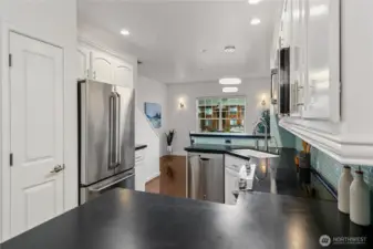 Pantry, bar seating on either side of kitchen