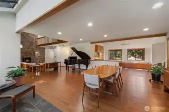 Generous great room layout combining dining, living, and kitchen areas, highlighted by warm wood tones, natural light, and an ideal setting for entertaining.