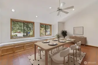 Staged eating area off the kitchen could be a second sitting room. with upholstered window seat