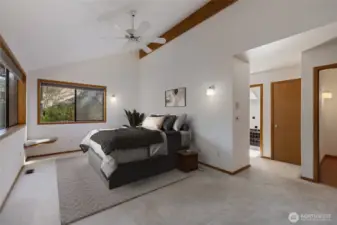 Primary bedroom with ensuite 5 piece bath.  Vaulted ceilings in the bedroom  & skylight above soaking tub for twilight soaks.  Virtually staged.