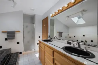 Primary bath with soaking tub and double vanity.