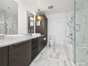 Indulge in the luxurious marble primary ensuite, featuring a sleek double vanity, elegant finishes, and a spa-like atmosphere for ultimate relaxation.