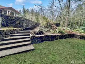 Looking up from terraced area towards rear of home.