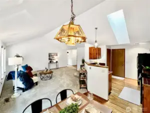 Looking towards great room from dining room. Kitchen features hardwood floors and skylight.