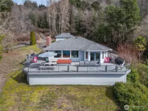 Expansive view deck with easy access from the upper level living areas and along both sides to front of house.