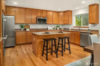 Warm and inviting Kitchen with miles of maple cabinetry, granite surfaces and SS appliances