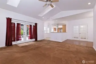 Another shot of the living room, with the dining room doors on the right, and the leading into the kitchen in the middle, and French doors leading out to the back deck on the right.