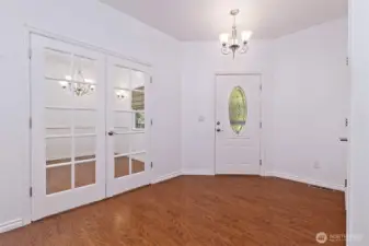 Entry, with French doors leading to the formal dining room.