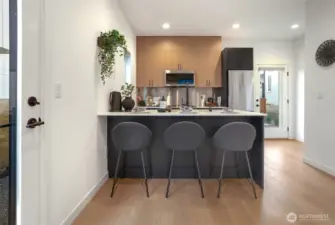 Counter seating in kitchen, plus space for an additional table.