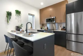 Stainless appliances and backsplash. Efficient use of space = a pleasurable cooking experience.