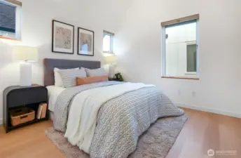 The large primary bedroom fits a king-size bed, with added room for furniture.