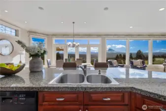 Rich granite surfaces, expansive island and custom cabinetry