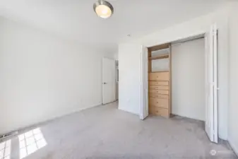 Closet with built-in shelves and drawers in guest bedroom #1.