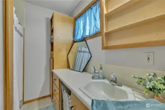 The 3/4 bathroom has much storage and is the main bathroom for the primary suite.