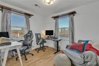 This is one of the secondary bedrooms currently used as an office. Since the home is perch up high on a corner lot, there is much natural light that comes through. You can see the views in the distance. A great combination of privacy yet minutes away from all amenties.