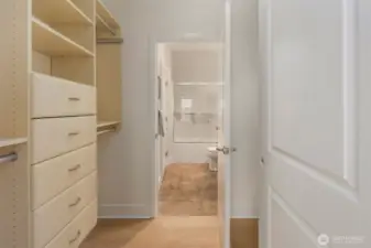 Pass through primary closet with added custom closet system.