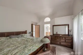 Primary bedroom with vaulted ceiling, walk in closet, and 5 piece bath
