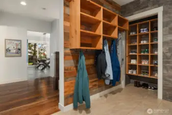 Function meets luxury with a 4-car garage featuring epoxy flooring and two convenient entrances. One leads into a beautifully designed mudroom with a live-edge wood bench and custom built-ins to keep life organized in style.