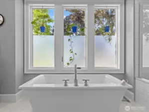 Unwind in the deep-soaking tub, surrounded by privacy film that ensures seclusion while still allowing an abundance of natural light to fill the space.