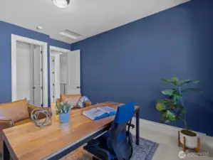 The secondary bedroom offers flexible use as a dedicated work-from-home space, complete with spacious walk-in closets for ample storage.