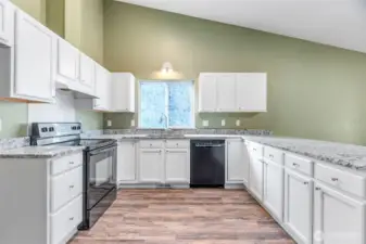 The spacious kitchen with granite counters and lots of space.