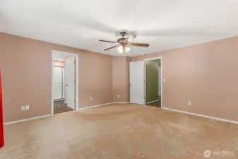 Thisis the primary bedroom. The primary bathroom is through the door on the left. The door on the right leads to the hallway and additional bedrooms.