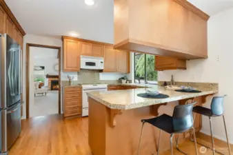 Plenty of counterspace and cabinets in your kitchen with granite tile counters and newer stainless refrigerator.