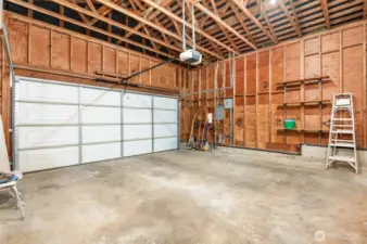 2 car, side by side garage with shelving.